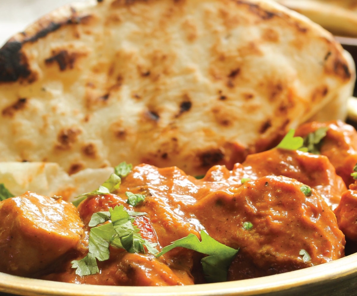 Chicken curry in a bowl with naan bread