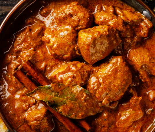 Delicious Indian Cuisine, Kolkata, Newport Pagnell Bowl filled with curry, garnished with cinnamon sticks