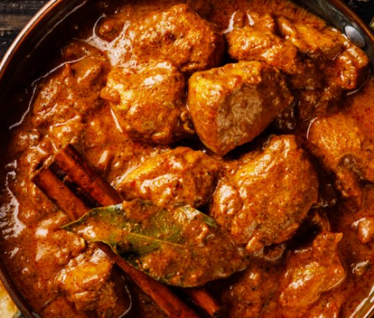 Delicious Indian Cuisine, Kolkata, Newport Pagnell Bowl filled with curry, garnished with cinnamon sticks